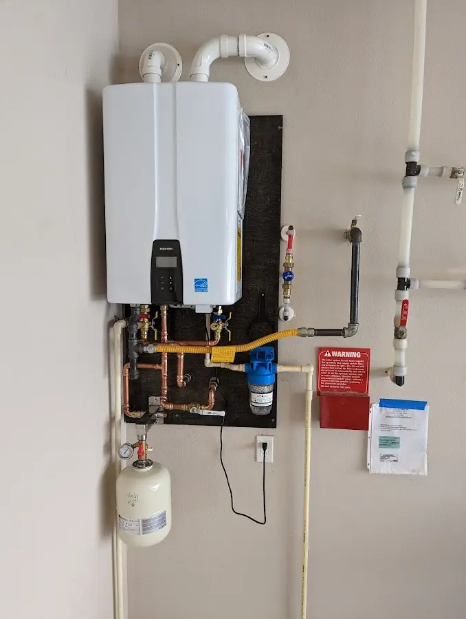 Professional plumber installing copper piping in a New Kensington home